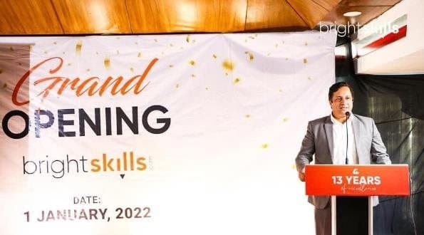 Anower Sadath Kabir speaking at a lectern beside the Bright Skills grand opening banner dated 1 January 2022