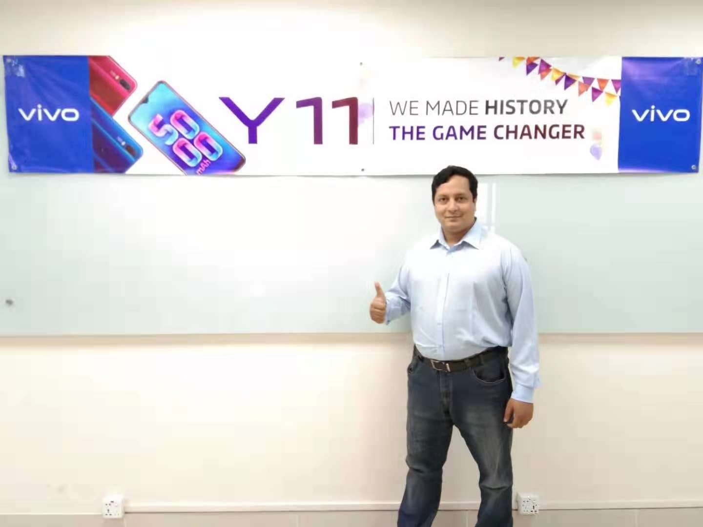 Anower Sadath Kabir giving a thumbs-up beneath a banner reading “Y11 — We made history”