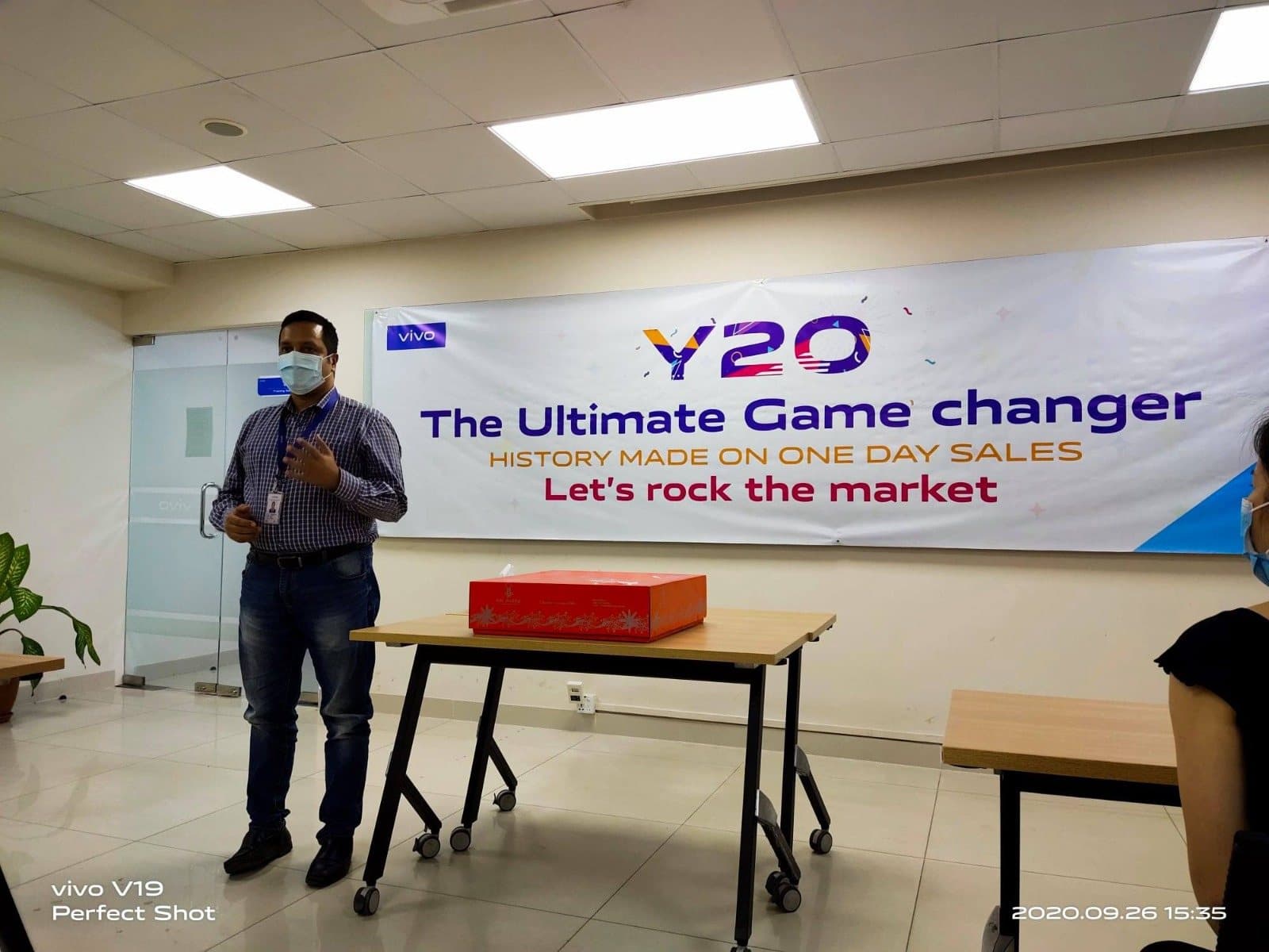 Anower Sadath Kabir speaking under a banner celebrating record one-day Y20 sales